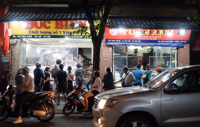 Theo ghi nhận, từ khi Hà Nội nới lỏng một số biện pháp phòng dịch tại các khu vực "vùng xanh", lượng người dân ra đường trên các tuyến phố tăng đột biến, một số hàng quán xuất hiện tình trạng chưa bảo đảm giãn cách. Trong ảnh: Một số người dân đứng dưới lòng đường khiến các phương tiện tham gia giao thông khó khăn trong việc di chuyển