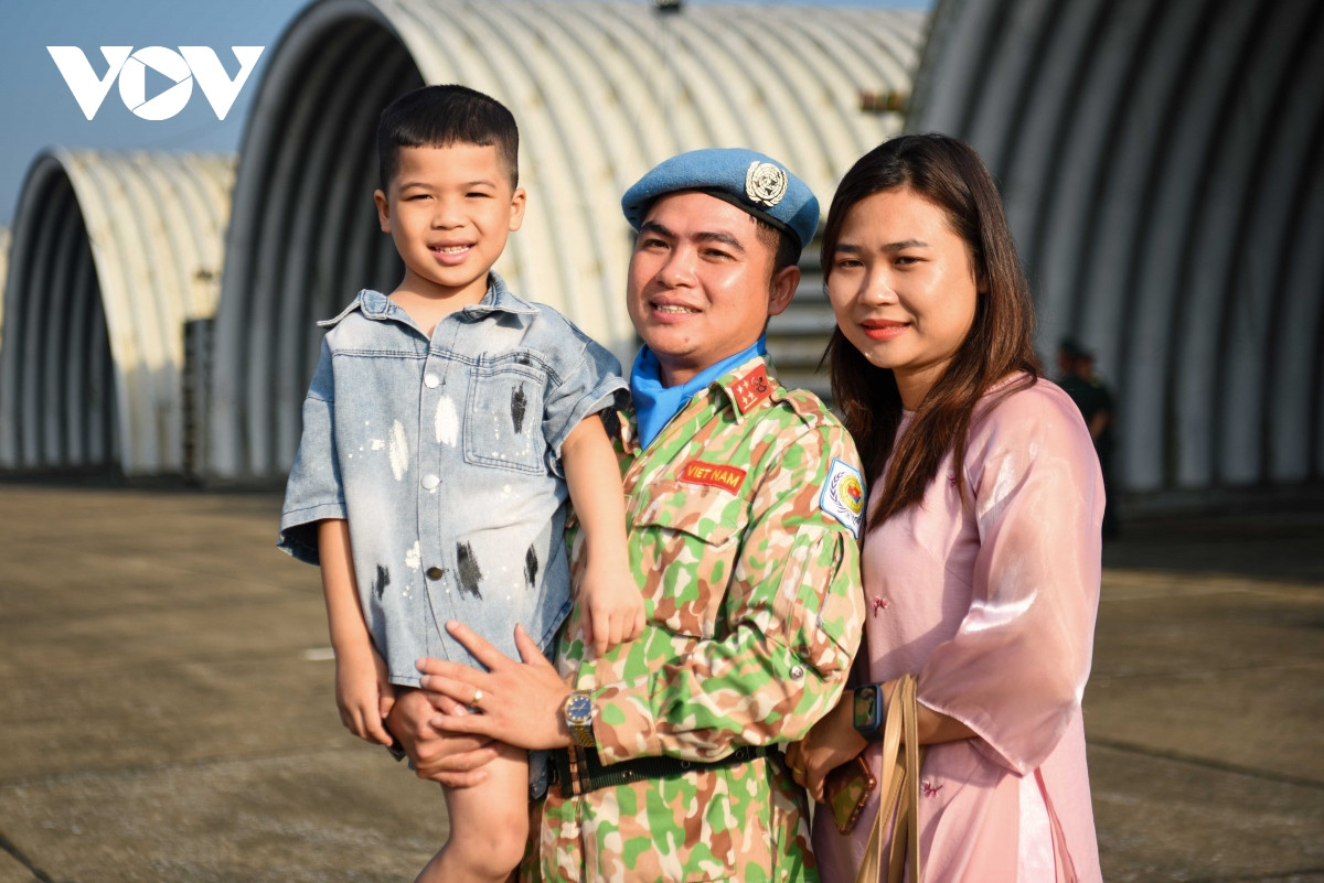 Tiễn người thân đi làm nhiệm vụ quốc tế, chị Nông Thị Nhung, vợ Đại úy Bùi Anh Đông chia sẻ: "Khi anh đi lần đầu thì anh ấy hiểu và cảm thông về những khó khăn ở Abyei, đó là những động lực chính mà anh muốn sang để góp một phần nhỏ bé của mình gìn giữ hòa bình ở nơi đến. Đó là lý do khiến cho mình cảm động và vì thế mà bản thân mình cũng kiên cường hơn, ở nhà một mình, vững vàng để nuôi con và lo toan cuộc sống". Trong ảnh: Gia đình Đại úy Bùi Anh Đông.