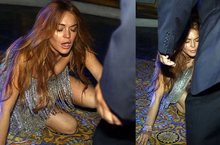 Vì bất cẩn, Lindsay Lohan bị ngã chỏng chơ ngay trên thảm đỏ LHP ở Italy và làm mồi cho cánh săn ảnh.