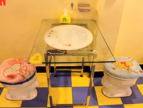 Nhà hàng House of Poo, Bắc Kinh, Trung Quốc. Ở đây, thực khách không những không ngại mà còn tỏ ra hứng thú khi ngồi trên nắp "bồn cầu" và thưởng thức món ăn trong... "bình phóng uế". Chỗ ngồi dành cho thực khách giống hệt bồn cầu, phía trên phủ lớp thảm in hình những nhân vật hoạt hình ngộ nghĩnh. Các khách hàng cho biết, đồ ăn ở đây không thực sự ngon nhưng họ đến đây vì sự tò mò, hứng thú với cách bài trí độc đáo của nhà hàng này