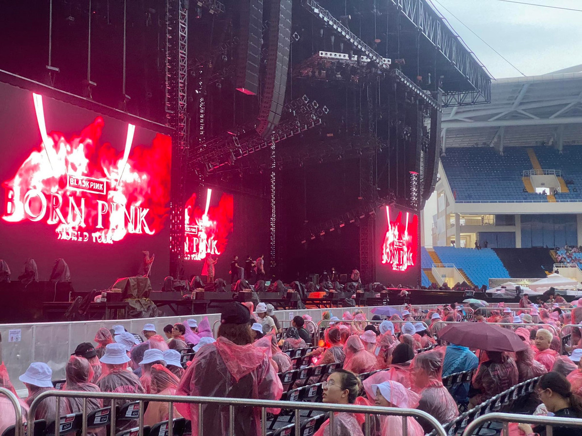 Trước đó, người hâm mộ phải mặc áo mưa vào sân khấu tìm chỗ ngồi do cơn mưa bất chợt lúc 17h20.