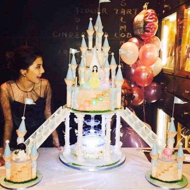 Bữa tiệc sinh nhật của Ngô Thiên Ngữ được làm theo chủ đề công chúa với chiếc bánh hình lâu đài của nàng lọ lem và trên bàn tiệc được trang trí rất nhiều những đôi giày thủy tinh màu hồng.