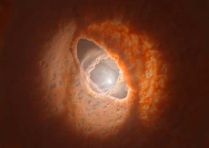 3. Hành tinh cực hiếm GW Ori trông giống hình mắt bò. GW Orionis có ba ngôi sao tập trung trong ba vòng bụi dao động. Các nhà thiên văn học nghĩ rằng, có thể có một hành tinh ba mặt trời hiếm gặp trong hỗn hợp này. Hệ sao, được gọi là GW Orionis (hay GW Ori) và nằm cách Trái đất khoảng 1.300 năm ánh sáng, có ba vòng màu cam đầy bụi lồng vào nhau. Hệ sao GW Ori thực sự trông giống như một con mắt bò khổng lồ trên bầu trời. Tại trung tâm của hồng tâm đó là ba ngôi sao - hai ngôi sao bị khóa trong quỹ đạo nhị phân chặt chẽ với nhau, và ngôi sao thứ ba xoáy rộng xung quanh hai ngôi sao kia. Đây là loại hành tinh hiếm nhất trong vũ trụ, một thế giới đơn lẻ quay quanh ba ngôi sao cùng một lúc.