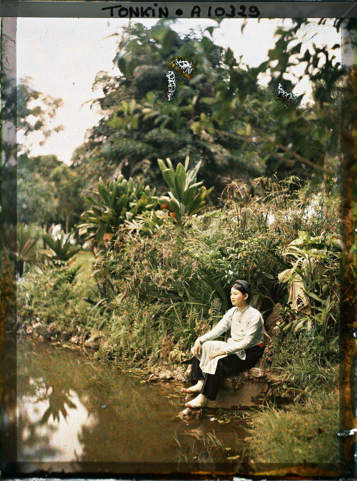 Người phụ nữ này là vợ một người châu Âu, ngồi bên ao nước của một công viên.