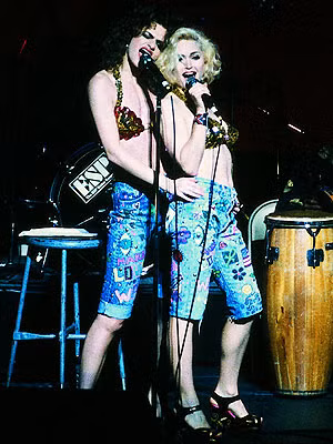 Bộ đồng phục với bạn diễn Sandra Bernhardt trong màn trình diễn ca khúc "I got you babe" tại lễ từ thiện ủng hộ nạn nhân AIDS năm 1989 của Madonna khiến khán giả kinh ngạc. Đây có lẽ là một trong những bộ trang phục trình diễn ấn tượng nhất của cô. Cả áo và quần có được đều là do màu vẽ trên thân thể của hai nữ nghệ sĩ.