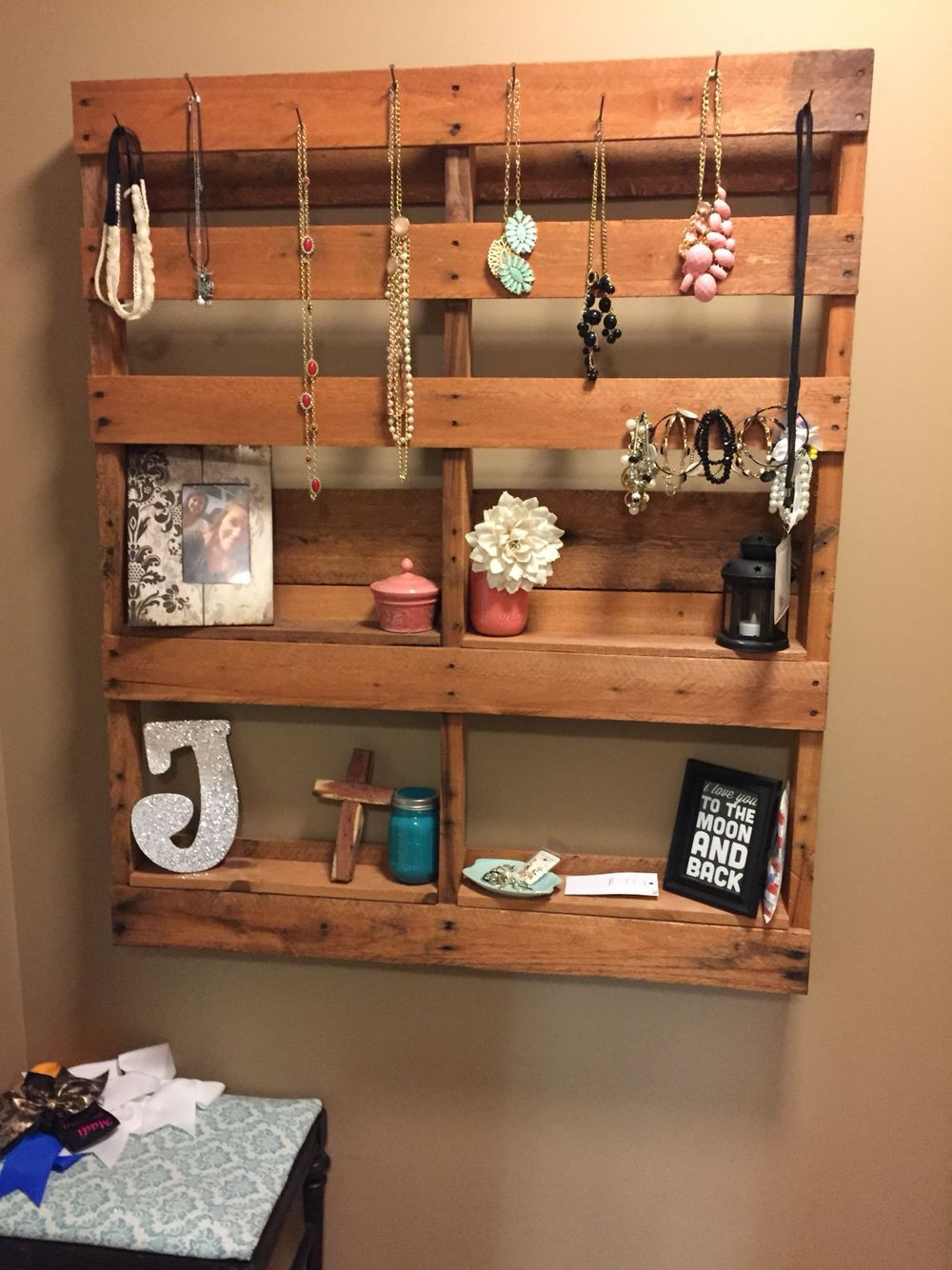 4. Một cô nàng yêu thời trang và phong cách vintage thì hẳn nhiên nên tự làm chiếc giá treo phụ kiện kiêm để đồ kỷ niệm như thế này. Rất đơn giản thôi, bạn chỉ việc đóng những thanh gỗ dày một chút lên một tấm gỗ lớn như hình. Chính những thanh gỗ dày này sẽ là bệ đỡ cho những khung ảnh, những món đồ lưu niệm của bạn. Còn những vòng cổ, vòng đeo tay thì chỉ việc dùng đinh đóng thành móc trên thanh gỗ và treo lên. Nhưng nhớ là đừng để đinh nhô ra ngoài quá nhiều nhé!