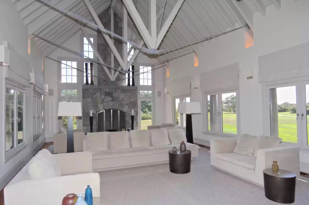 Bên trong có một phòng tiếp khách cỡ lớn, kết hợp cấu trúc trần cao và lò sưởi bằng đá. Ảnh: Realtor.