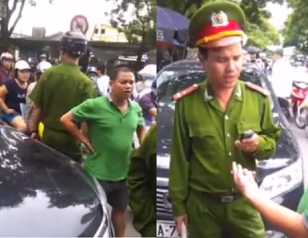 Tài xế xe con (áo xanh) bị Công an phường bắt lỗi.