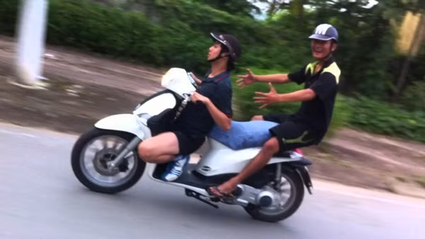 Hai thanh niên giỡn mặt "tử thần" để biểu diễn trên xe máy.