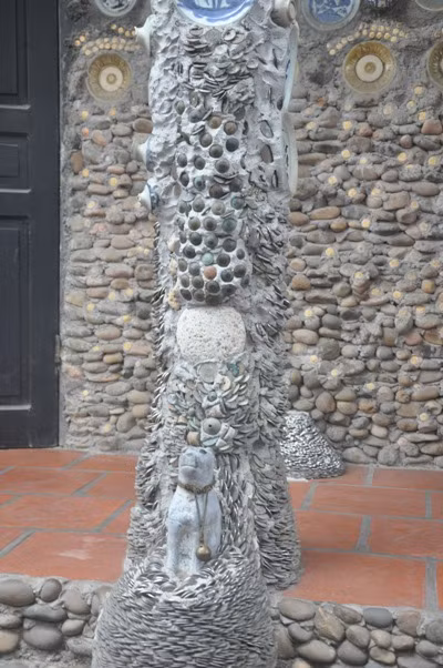 Phía sau ngôi nhà cũng trở nên độc đáo bởi hang trăm viên đá tròn ông Trường nhặt được rồi mang về gắn lên tường.