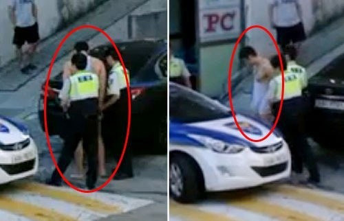 Hình ảnh Julien Kang bị cảnh sát dẫn giải về đồn.