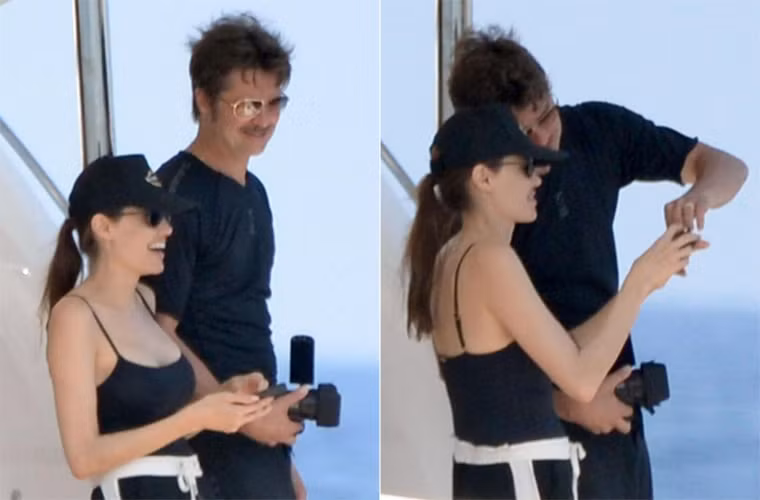 Jolie mặc chiếc áo hai dây cùng chiếc quần short đen, Pitt cũng mặc bộ đồ đen, đứng bên cạnh.