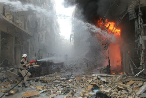 Lính cứu hỏa Syria đang cố gắng dập lửa sau cuộc không kính của quân đội Syria vào ngày 7/3/2014 ở Aleppo. Khoảng 140.000 người Syria đã thiệt mạng ở Syria sau khi các cuộc nổi dậy chống chính phủ của ông Assad bắt đầu vào tháng 3/2011.