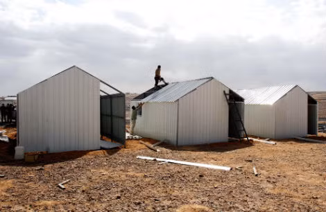 Công nhân người Jordan đang thi công ngôi nhà tạm ở trại tị nạn mới gần thành phố Azraq của Joran vào ngày 25/3/2014. Đây là trại tị nạn thứ 3 cho người Syria ở Jordan với sức chứa gần 3.000 người.
