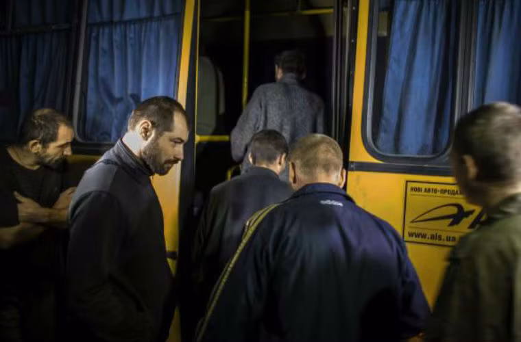 Binh sĩ ly khai lên xe buýt trở về Donetsk sau khi được trao trả.