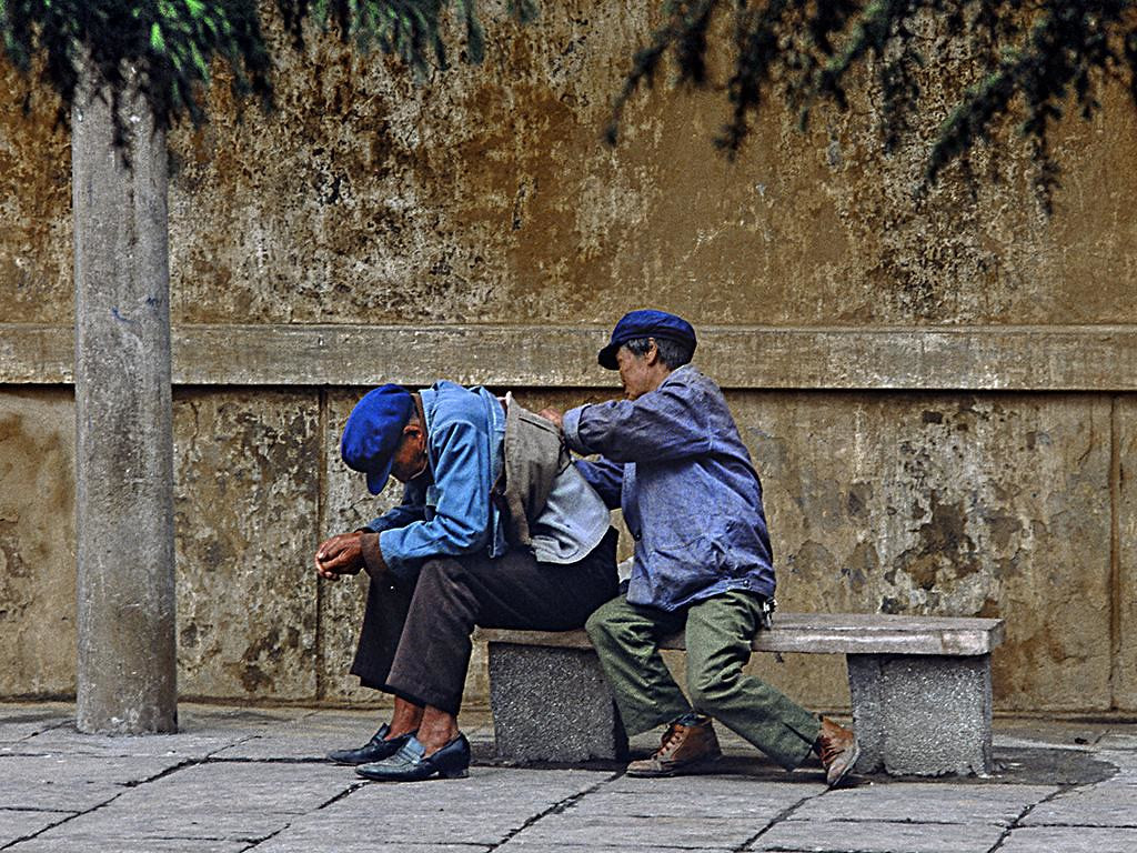 Dân làng tẩm quất cho nhau trên ghế đá.