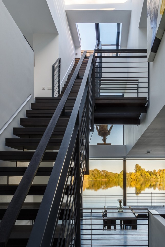 Khoảng thông tầng trung tâm mang ánh sáng ban ngày dồi dào vào tầng hầm và kết nối không gian bên trong với sân thượng.