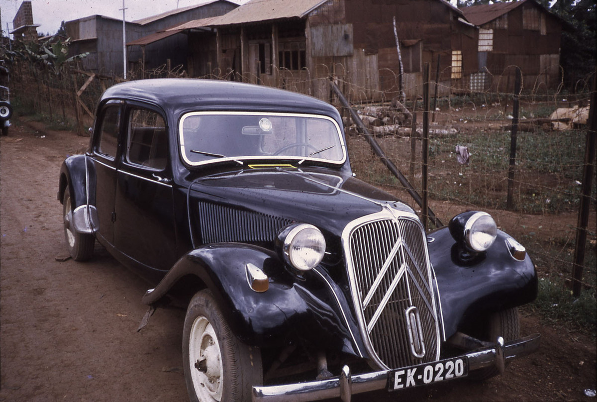 Chiếc xe bên ngoài một khu dân cư tồi tàn..