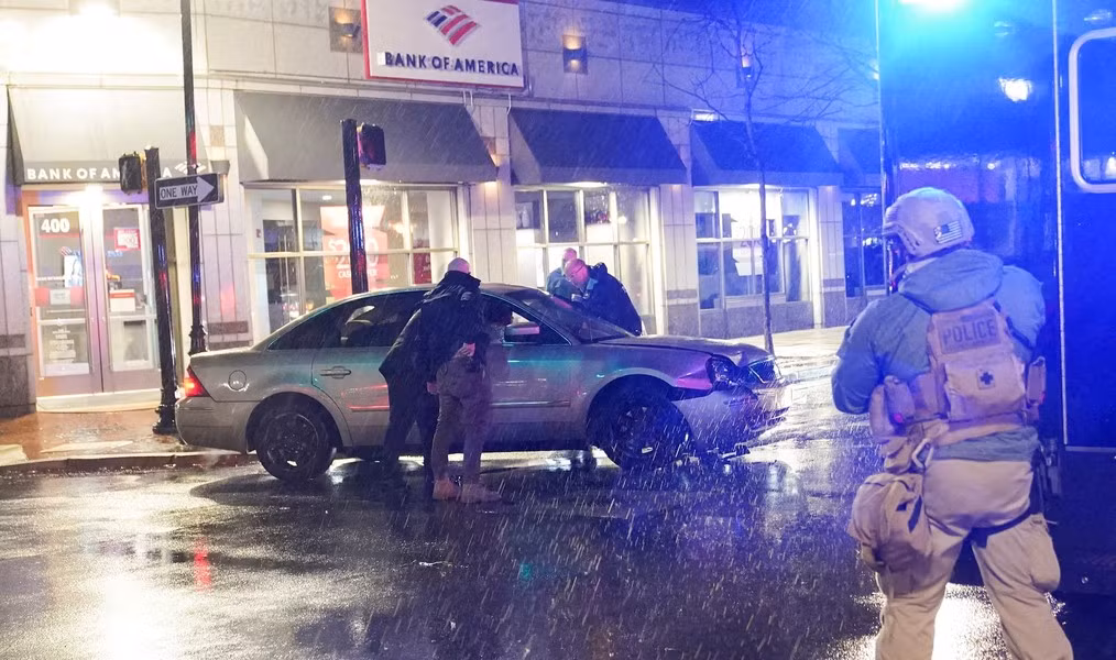 Lực lượng an ninh kiểm tra ô tô đâm vào chiếc SUV của Sở Mật vụ đang phong tỏa tuyến đường khi Tổng thống Mỹ Joe Biden rời trụ sở chiến dịch tranh cử của ông ở Wilmington, bang Delaware, ngày 17/12/2023.