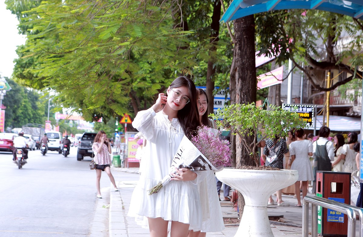 Một thiếu nữ thả dáng bên đường phố tấp nập của xứ Thanh.
