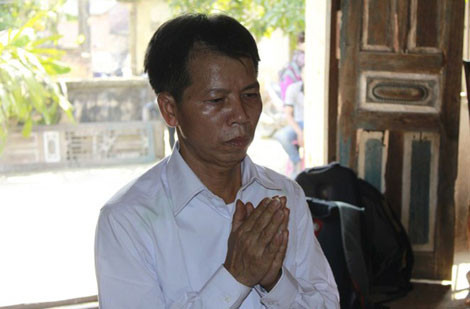 Ông Chấn trước bàn thờ gia tiên.