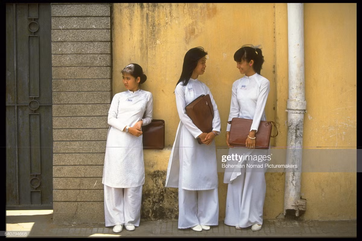 Nữ sinh trường PTTH Nguyễn Thị Minh Khai đứng bên ngoài cổng trường.