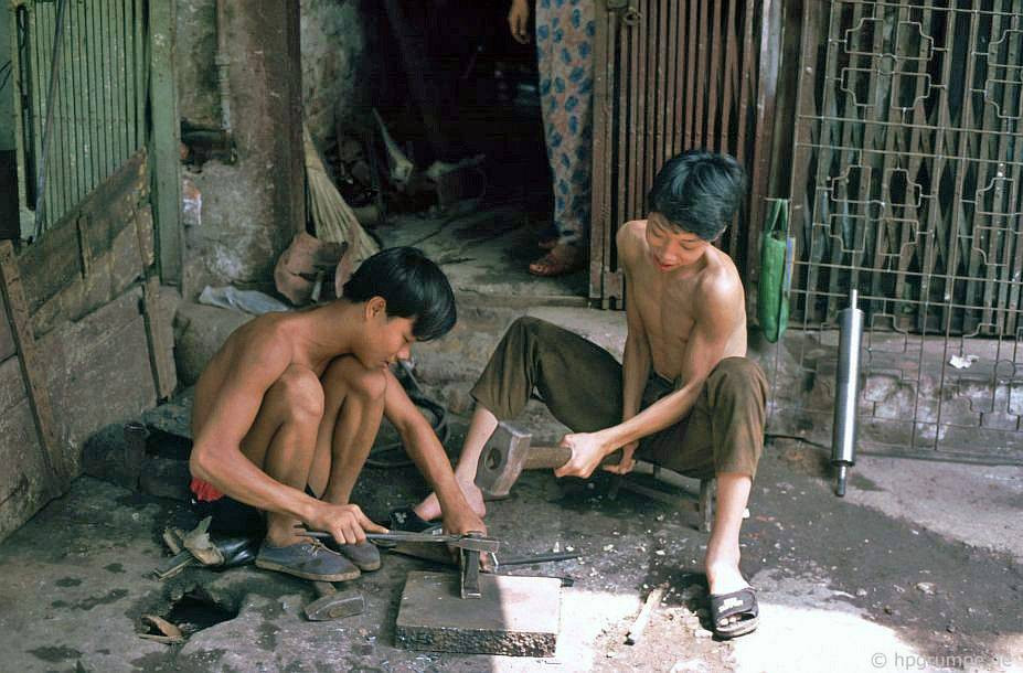 Các thợ sắt nhỏ tuổi quai búa trên vỉa hè, 1991.