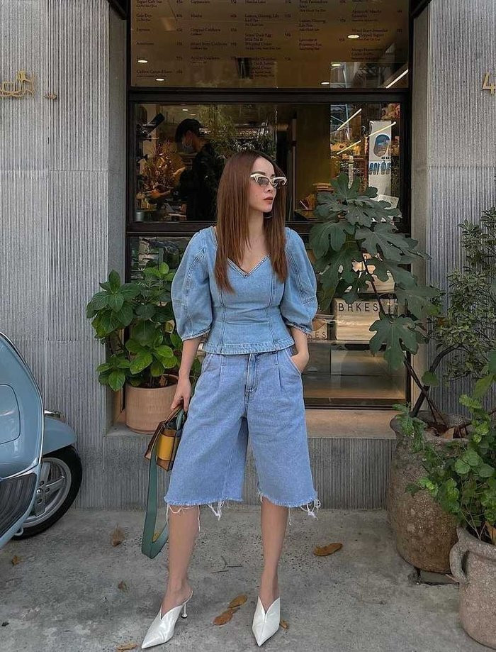 Yến Trang chọn cho mình set đồ được phối theo xu hướng dim-on-denim. Nữ ca sĩ phối áo tay bồng ton-sur-ton với quần bermuda ống rộng, hoàn thiện set đồ bằng một đôi giày cắt chữ V.