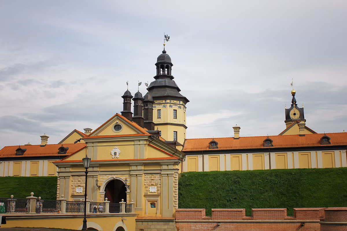 Kiến trúc sư Antoni Zaleski đã trang trí mặt ngoài lâu đài màu vàng bằng stucco (chất giả đá hoa) kiểu baroque. Các cổng của lâu đài cũng được tái kiến thiết và khối nhà bên trên cổng được đặt thêm chỏm nhọn. Ảnh: Minsk.roomer.by.