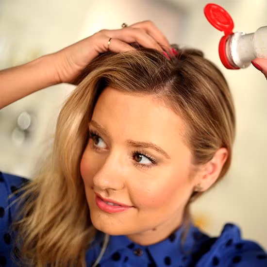 Dùng làm dầu gội khô. Phấn rôm có thể dùng như một loại dầu gội đầu khô trong trường hợp gấp gáp. Nguyên tắc hoạt động của dầu gội đầu khô là dùng những hạt phấn hút dầu trên da đầu. Rắc một ít phấn rôm lên phần chân tóc để chúng hấp thụ dầu. Nếu bạn có mái tóc đen, hãy trộn phấn với bột ca cao để tóc không bị trắng khi dùng. Sau khi rắc phấn, dùng ngón tay lùa qua mái tóc để phấn được phân bố đều.