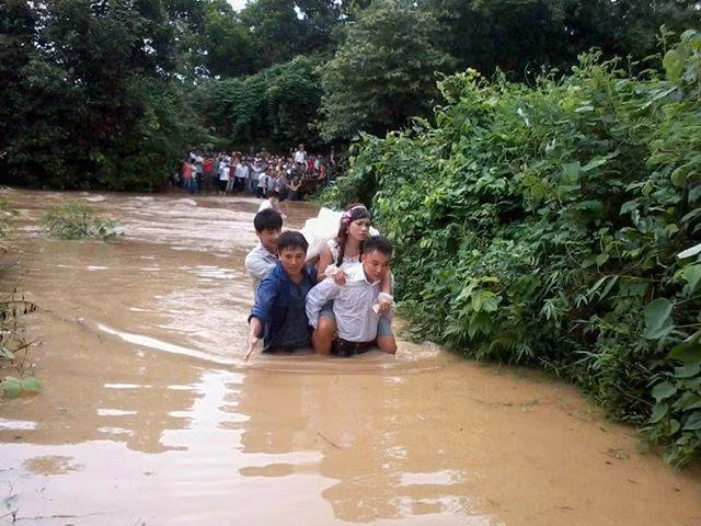 Giữa mênh mông biển nước, đám rước dâu vẫn cố gắng băng qua để đám cưới được trọn vẹn. Bức ảnh được cộng đồng mạng chia sẻ với nhiều cảm xúc buồn thương.