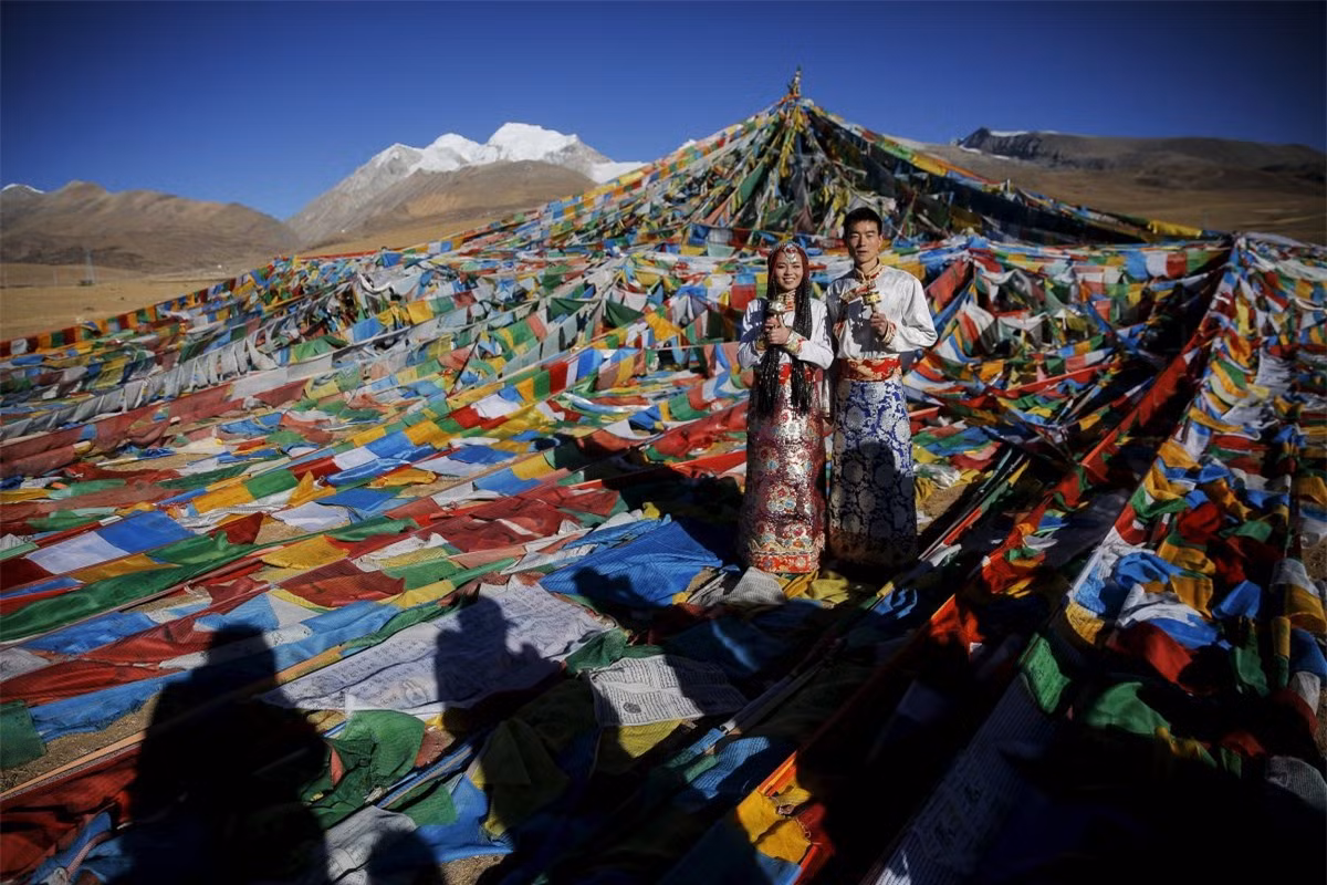 Hai vợ chồng tạo dáng chụp ảnh trong bộ trang phục truyền thống vào ngày cưới của họ ở chân núi NianqingTanggula.