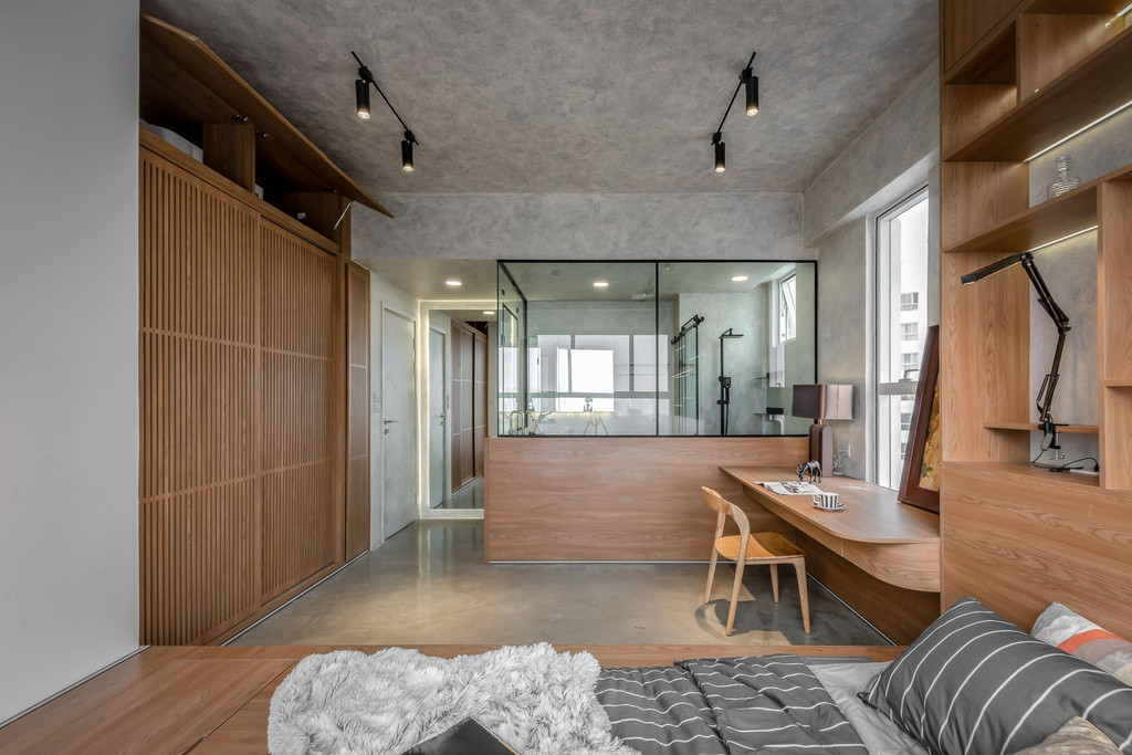 br/> Vẫn đề cao sự gọn gàng và tối giản, phòng ngủ cũng được sử dụng hiệu ứng bê tông cho sàn, trần và tường cùng đồ nội thất gỗ, tạo nên sự đồng bộ cho toàn bộ ngôi nhà.