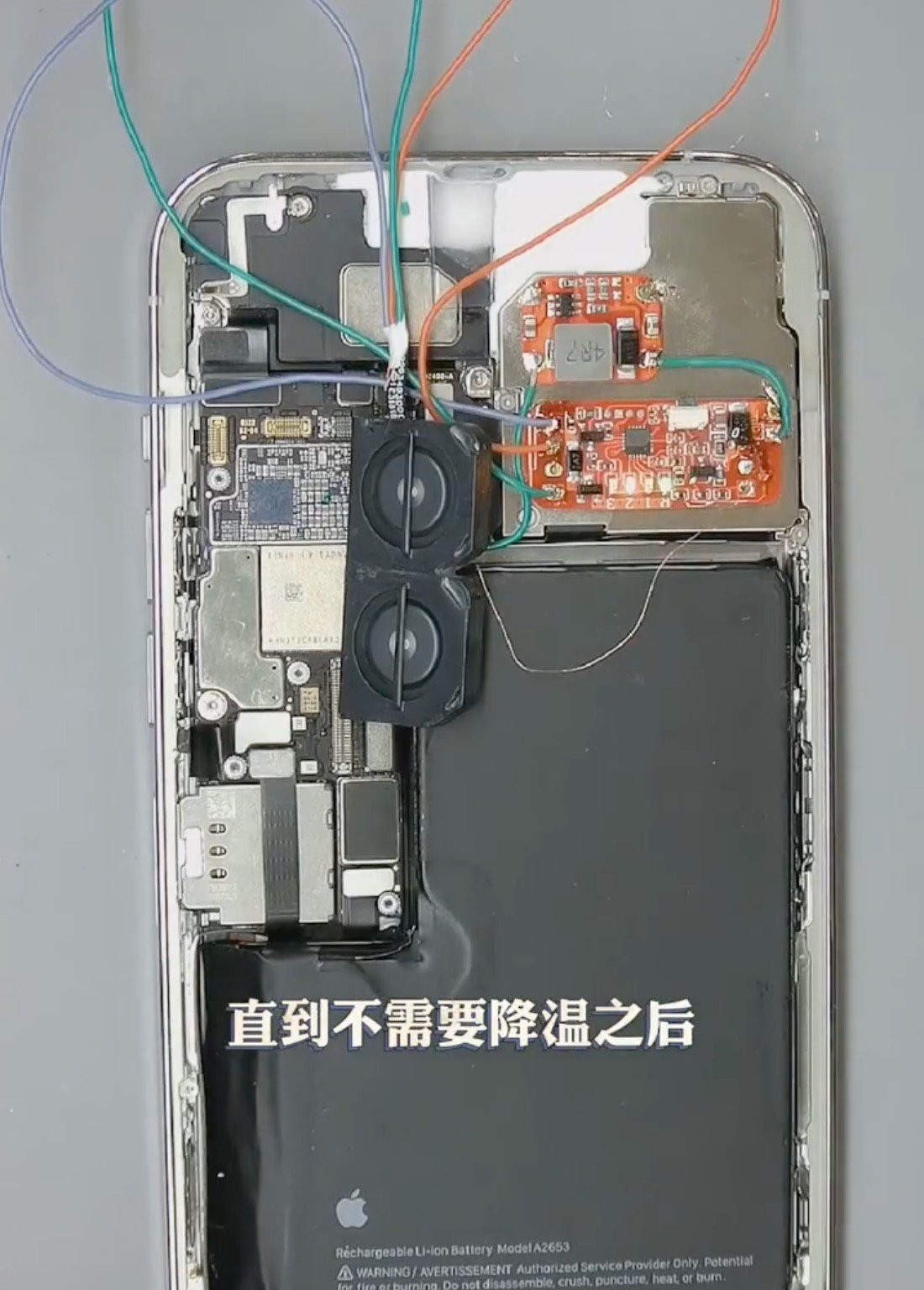 Chiếc iPhone 13 Pro Max được Changshun mua mới. Sau khi tháo bo mạch khỏi thân máy, kỹ sư này dùng mỏ hàn tách bộ tản nhiệt tích hợp (IHS), gắn quạt tản nhiệt để tăng khả năng làm mát rồi thêm loa ngoài cho âm lượng lớn hơn.