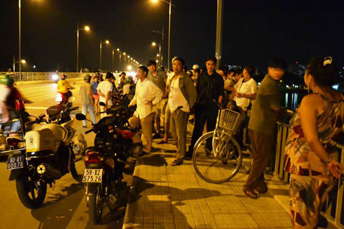 Rất đông người dân hiếu kỳ đứng trên cầu Hóa An theo dõi vụ việc.