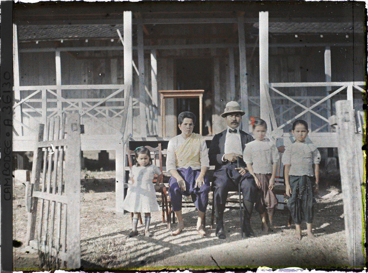 Gia đình một công chức Campuchia chụp hình trước ngôi nhà của mình. Người chồng mặc đồ phương Tây trong khi vợ mặc sampot truyền thống.