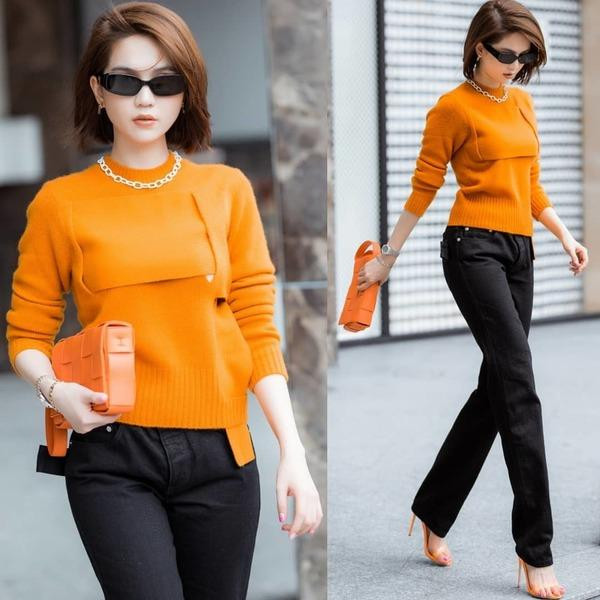 Ngọc Trinh thể hiện tài "chơi màu" cực hút mắt khi mix chiếc túi cam cùng áo len và giày cao gót đồng điệu.