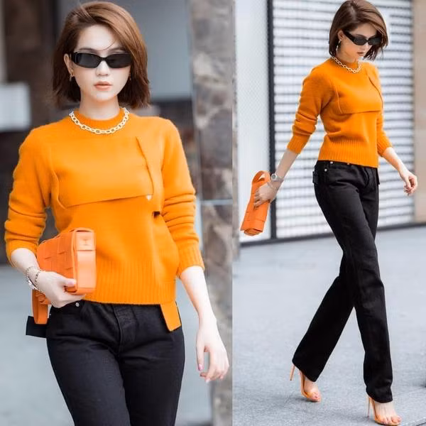 Ngọc Trinh thể hiện tài "chơi màu" cực hút mắt khi mix chiếc túi cam cùng áo len và giày cao gót đồng điệu.