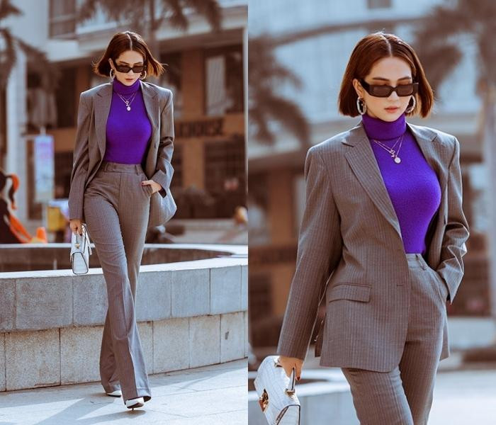 Áo len cổ lọ sơ vin cùng quần ống suông phủ kín giày cao gót là lối kết hợp khôn ngoan khiến người đẹp gia tăng đáng kể chiều cao. Chiếc áo len bó sát tuy "kín cổng cao tường" nhưng tôn vòng 1 nóng bỏng cùng vòng 2 thon gọn. Ba tông màu tím, trắng, xám mix không nhạt nhoà.