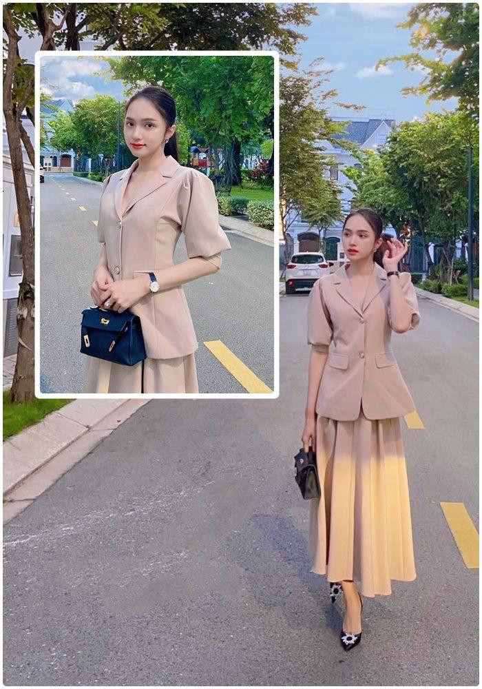 Hương Giang "lên đồ" đi làm chuẩn style công sở khi mix áo vest tay cộc cùng chân váy xếp ly, không thể thiếu túi xách hàng hiệu và giày cao gót.