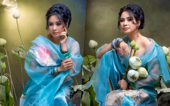 Mới đây, “Người đàn bà không tuổi’’ Thanh Lam làm cho khán giả xao xuyến với bộ ảnh chụp bên sen trắng vừa gợi cảm lại vừa thanh cao. Cô khoác lên mình chiếc áo voan xanh lệch vai khoe bờ vai trần, lấp ló hình xăm nhỏ sau lưng. Bà mẹ 2 con chọn kiểu tóc tết quấn cao, bông tai màu đỏ nổi bật và những chiếc vòng ngọc yêu thích. Chi tiết đắp hoa nổi càng làm tôn lên vẻ nữ tính, ngọt ngào của người phụ nữ đang yêu.