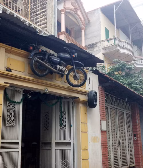 Ngôi nhà trở nên đặc biệt "quái dị" khi chủ nhân treo cả một chiếc xe máy ở trước cửa nhà.