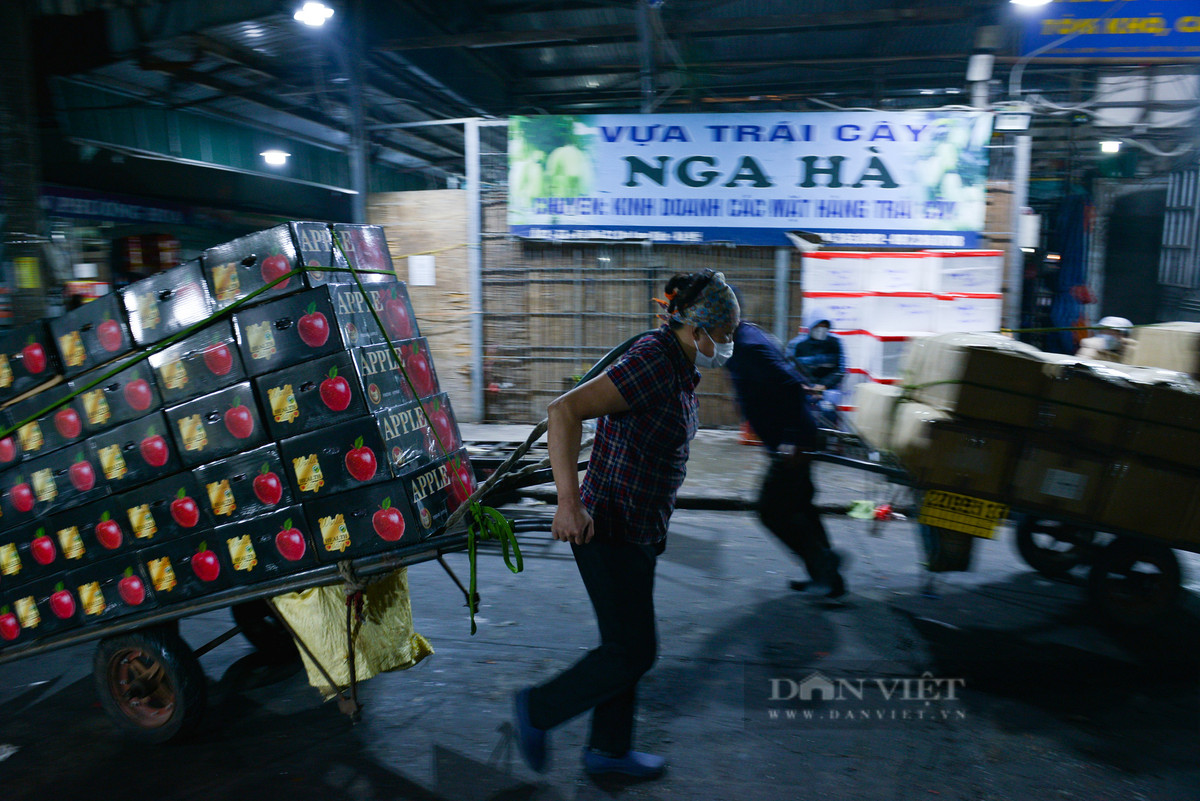 Có những xe hàng nặng hàng vài tạ do phụ nữ đẩy kéo là chuyện bình thường tại chợ đêm Long Biên.