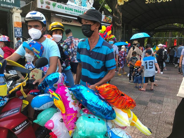 Người bán hàng tranh thủ bán thêm món đồ chơi nhiều màu sắc cho trẻ em, giá từ 20.000-40.000 đồng/món chia sẻ: "Dịch kéo dài nên chúng tôi không có thu nhập gì, chỉ mong bán được thêm chút hàng trong những ngày lễ để có tiền trả nhà trọ, ăn uống".