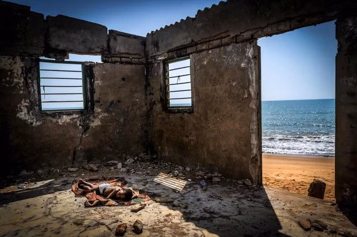 Giải thưởng "Nhiếp ảnh môi trường 2021" thuộc về bức ảnh "The Rising Tide Sons" của nhiếp ảnh gia người Tây Ban Nha Antonio Aragon Renuncio. Bức ảnh được chụp tại Togo, với một bé trai ngủ trên sàn căn nhà đã đổ nát trước sự xói mòn mà biển cả gây ra. Nước biển dâng là một vấn nạn đang đe dọa cuộc sống của người dân Togo cũng như các quốc gia Tây Phi, khiến hàng triệu người mất kế sinh nhai, nhà cửa bị phá hủy. Ảnh: Antonio Aragon Renuncio.