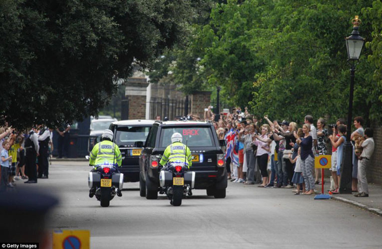 Đoàn xe hơi và mô tô hộ tống gia đình Kate-William về Điện Kensington trước sự hò reo và chúc tụng của người hâm mộ.