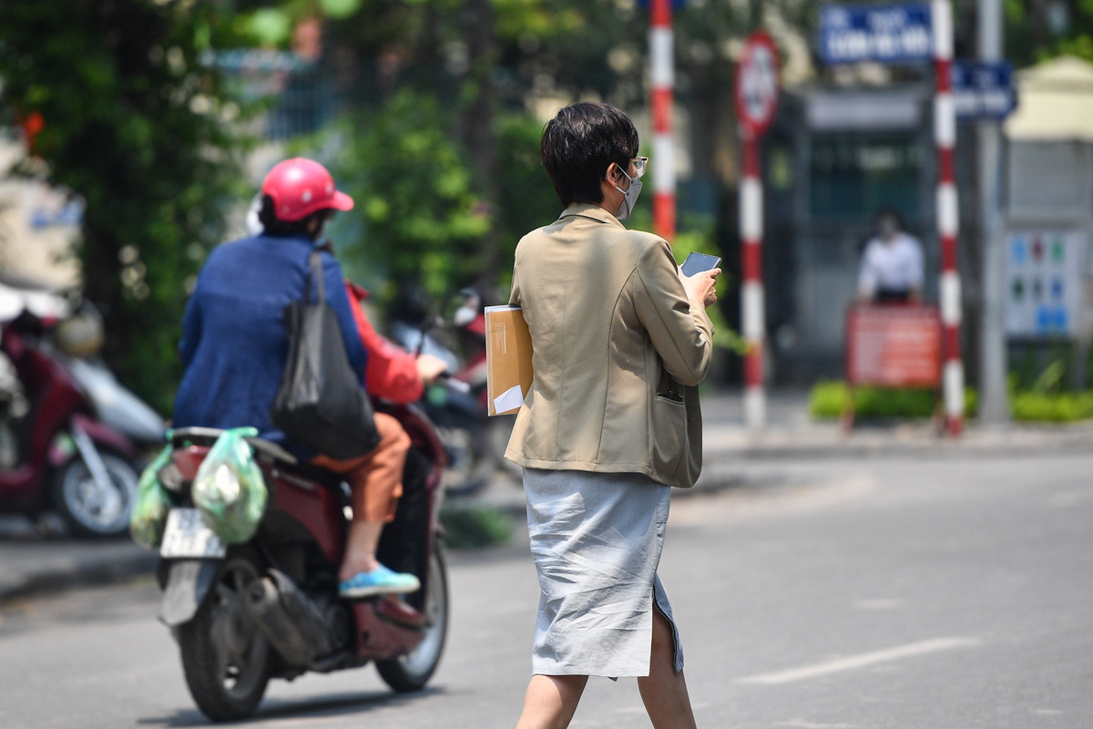 Một số người trở ra từ tòa nhà, trên tay cầm theo tập hồ sơ.