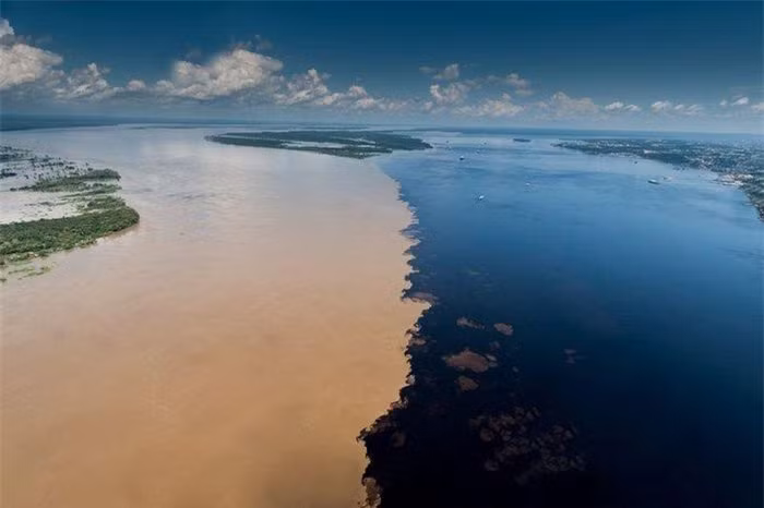 Ngã ba sông Rio Negro và Rio Solimoes (gần Manaus, Brazil):Rio Negro là nhánh lớn nhất của sông Amazon và là sông nước đen lớn nhất thế giới. Khi gặp Rio Solimoes - đoạn đầu của sông Amazon tại Brazil, hai sông chảy song song mà không lẫn màu. Ảnh:Amusingplanet.