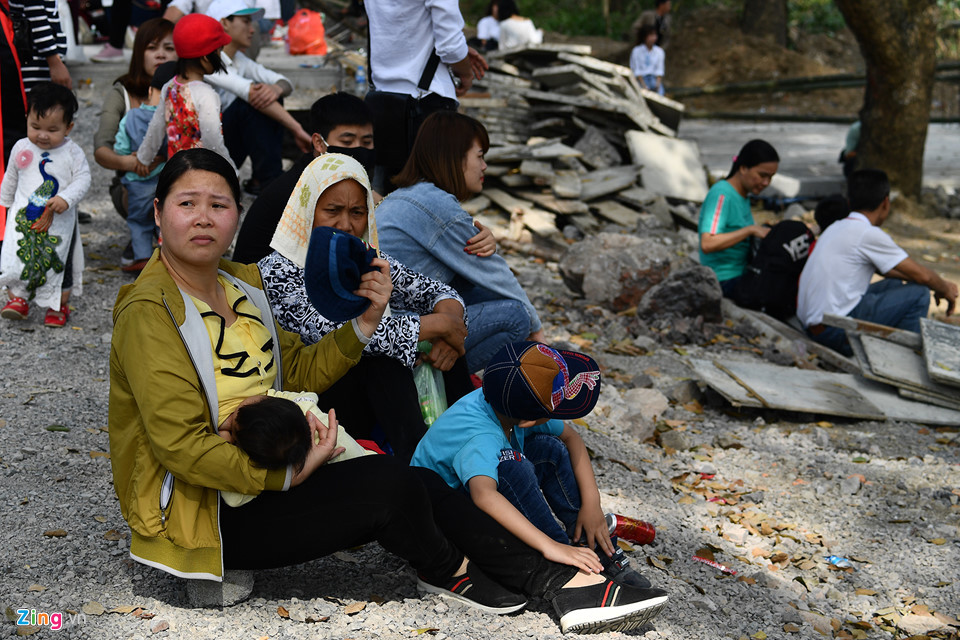 Nắng nóng và việc phải leo dốc nhiều khiến phần lớn du khách mệt mỏi ngồi thở dưới bóng cây. Xung quanh đó đầy vật liệu xây dựng chất đống.