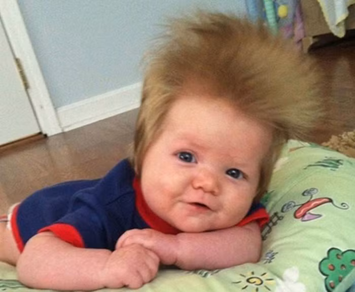 Em bé có mái tóc dài dựng ngược.